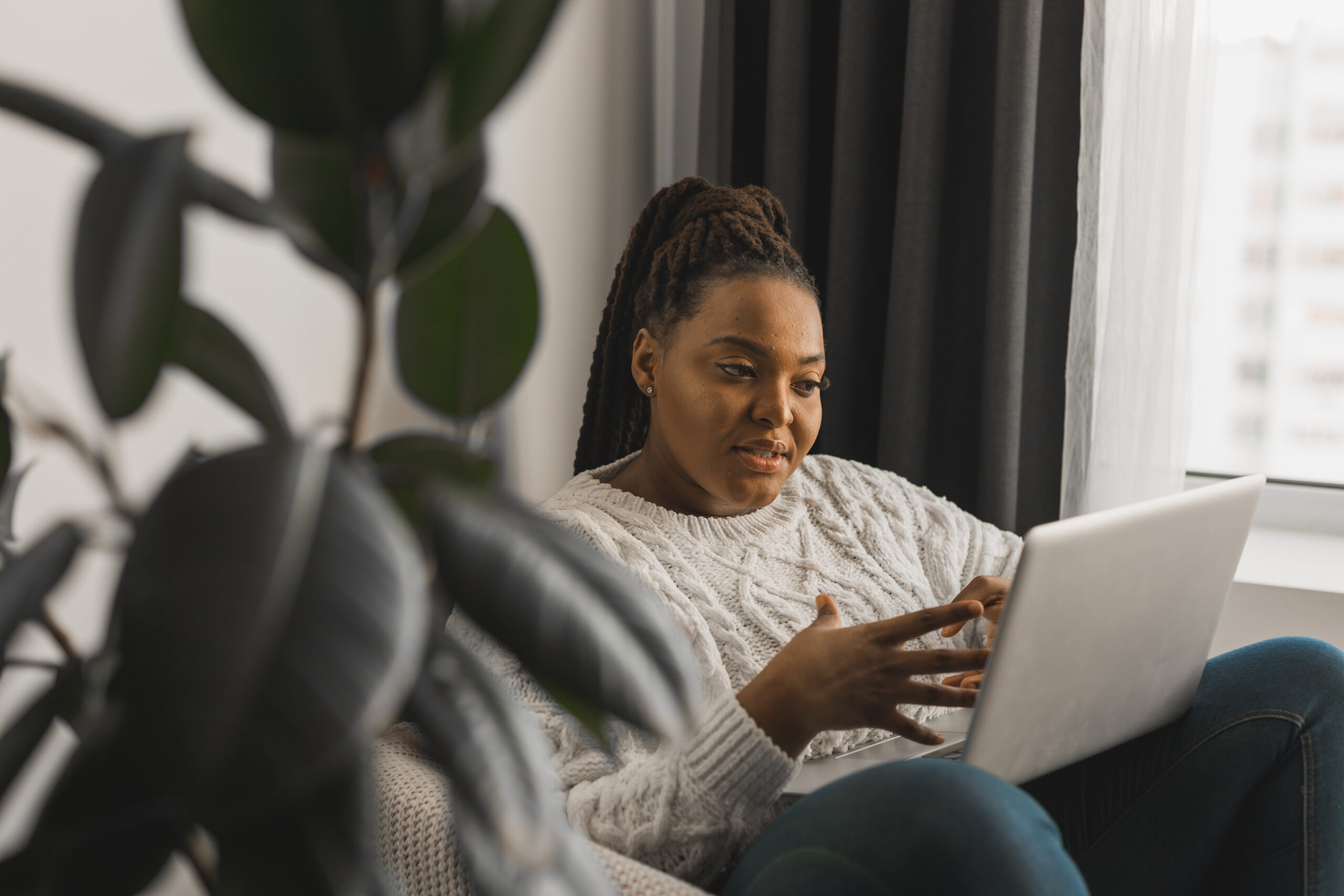 african american woman making video call in living room social networks and connection