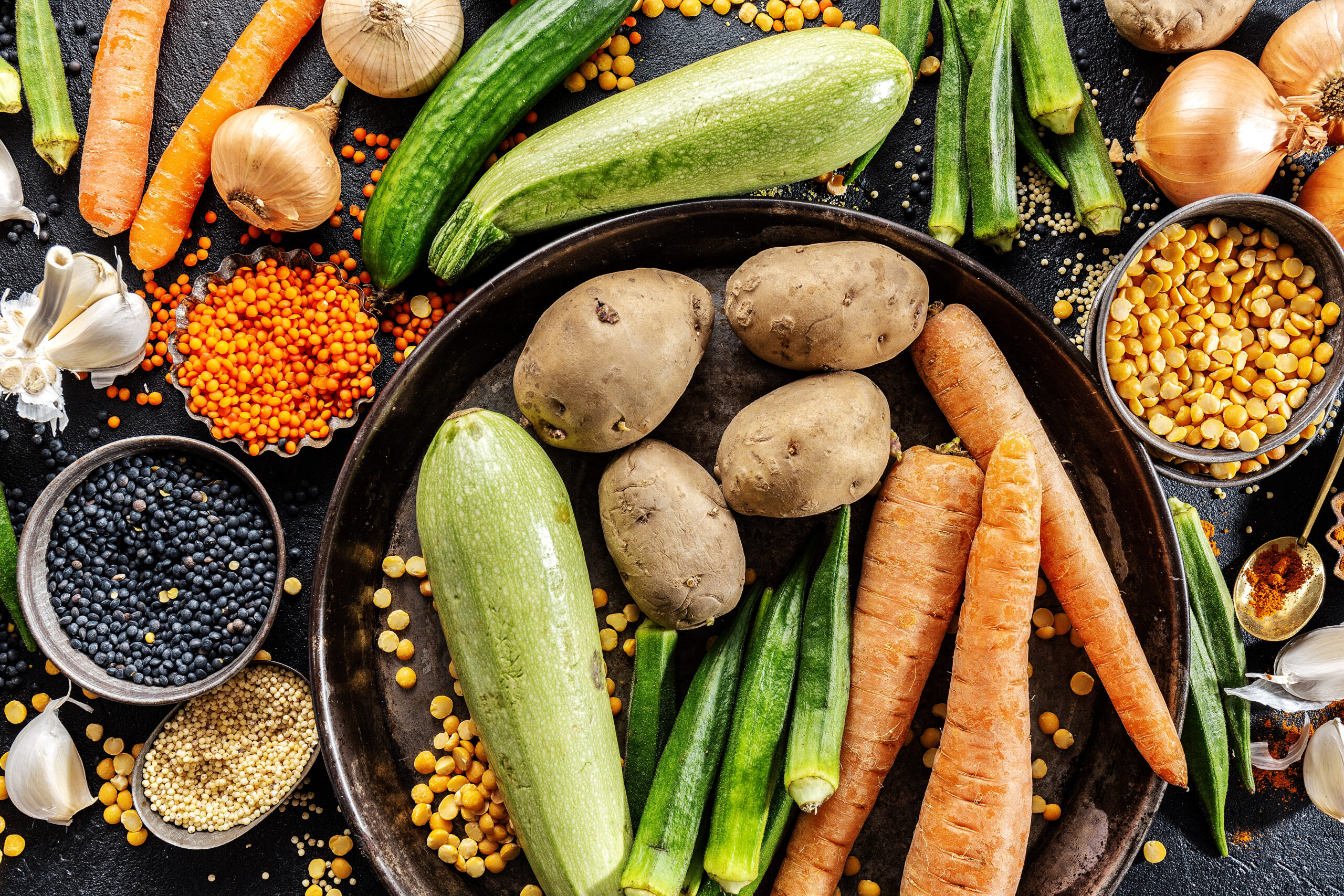 variety of fresh tasty vegetables on dark background